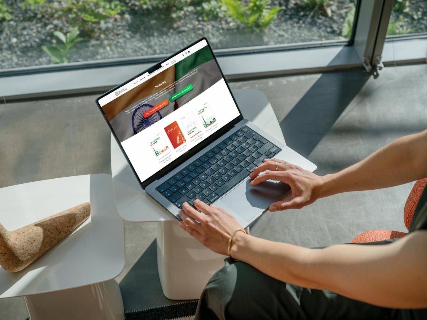 Laptop open on a website homepage, held on a lap