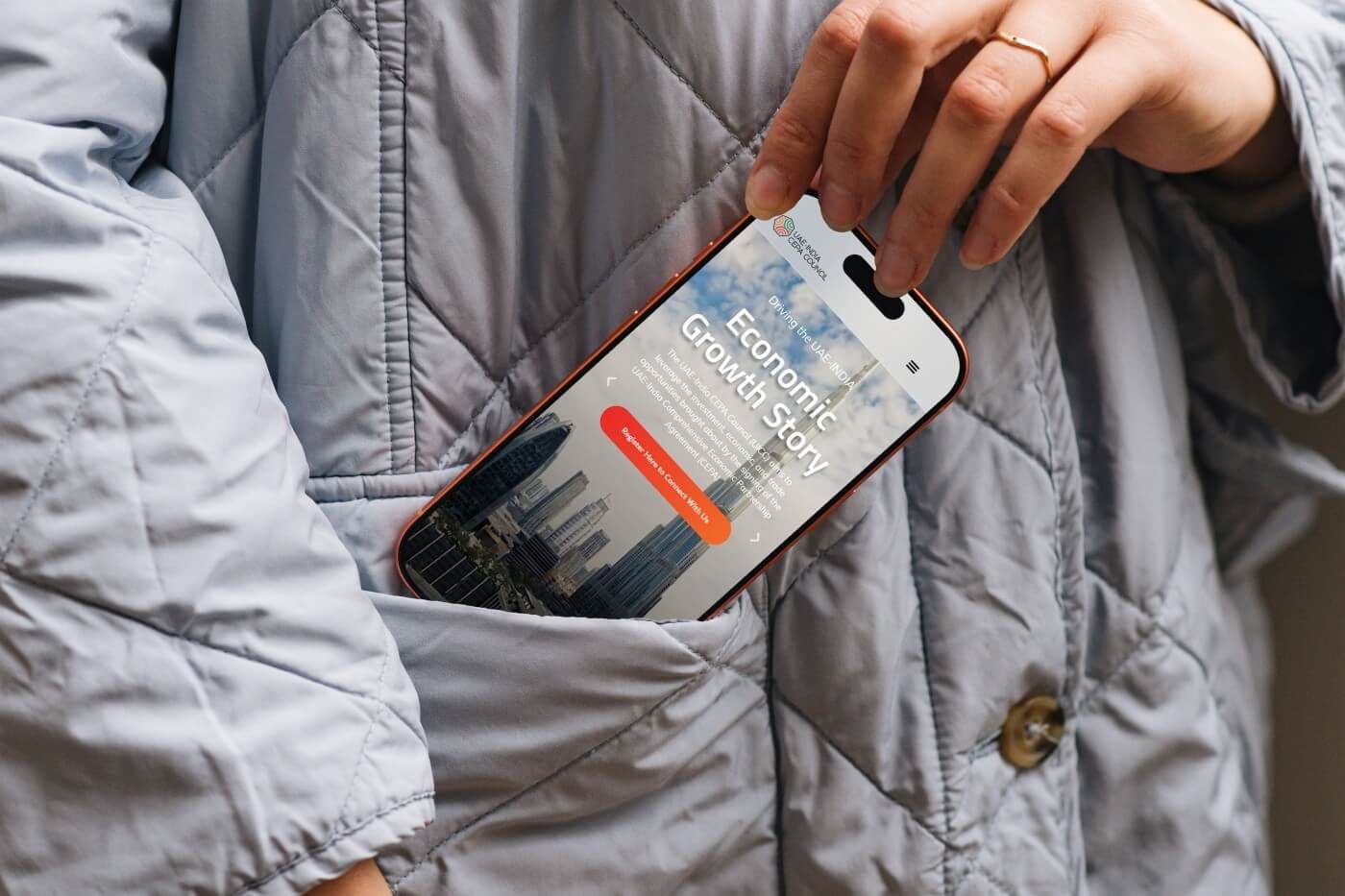 Phone in a coat pocket showing the mobile website